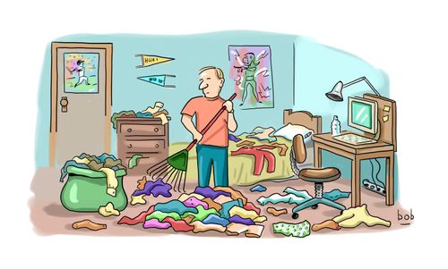 College kid rakes up his clothes on the floor in messy dorm room