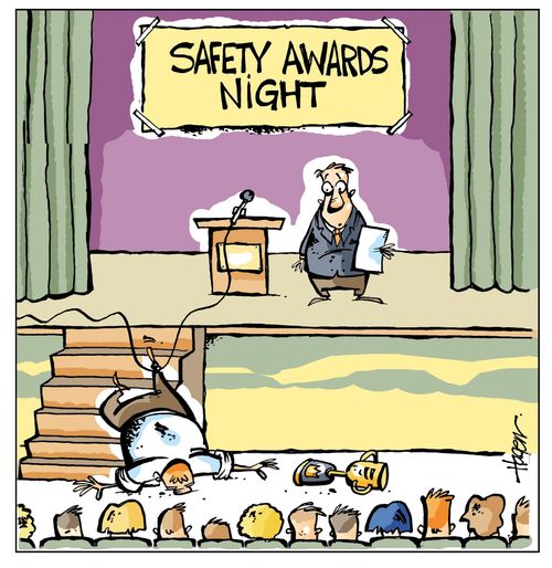 Man tripping over a cable at a safety awards night.