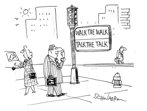 Street signposts - 'walk the walk' and 'talk the talk'.