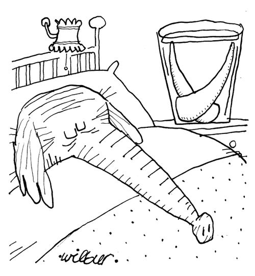 Elephant's tusks are in a glass by the bed.