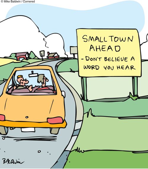 Sign reads: 'Small town ahead - don't believe a word you heard.'