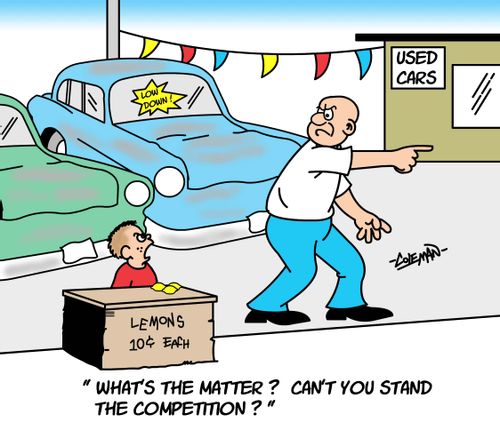 Boy Selling Lemons At Used Car Lot.