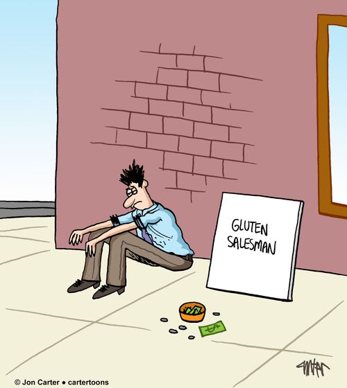 Beggar on street corner has sign which reads 'Gluten salesman'