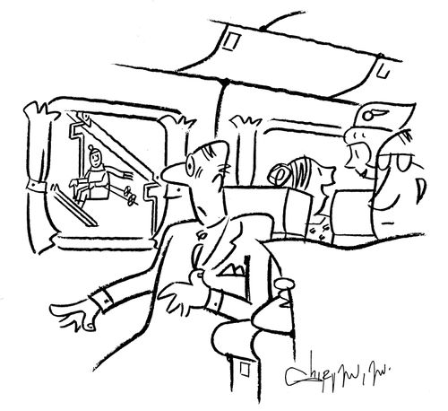 Man sees a ski lift outside the window of a plane.