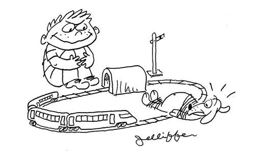Little boy ties his pet dog to a model railway track.