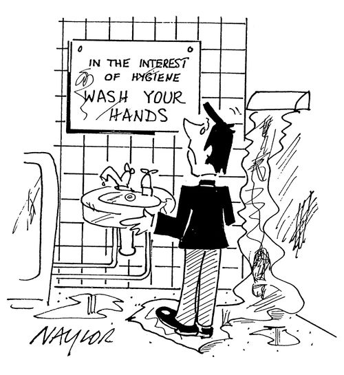 Man looking at 'wash your hands' sign in dirty bathroom.
