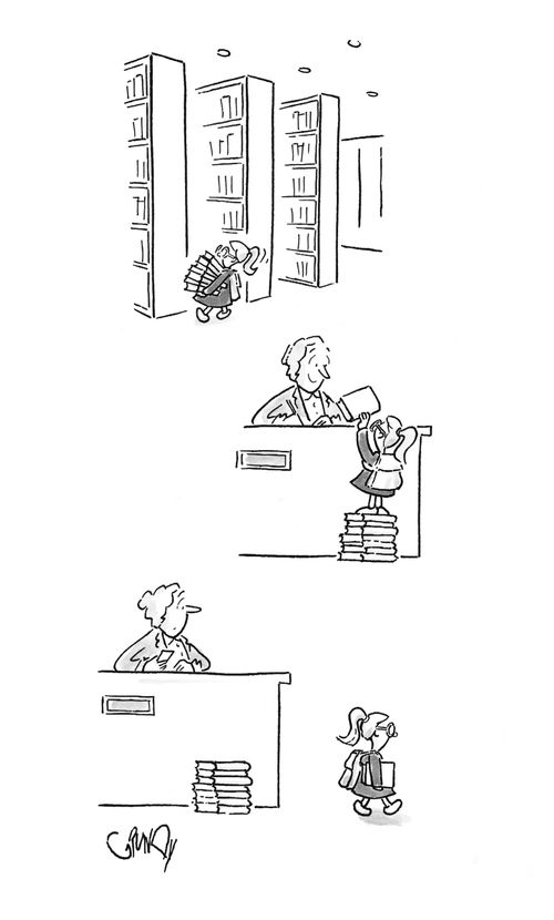 Small child checks out a book.