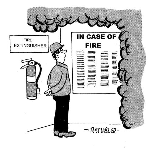 Worker reading instructions on how to put out fire while smoke billows all around him.