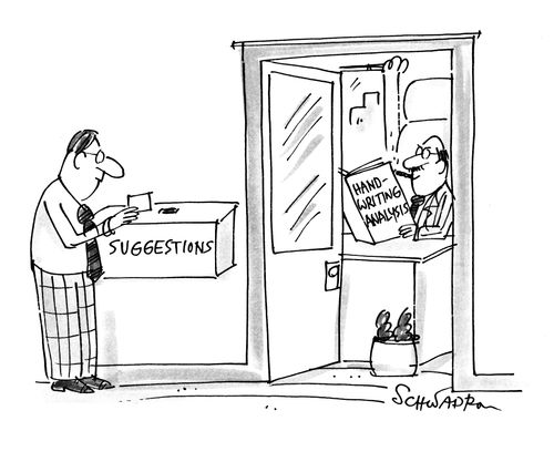 An executive is reading a book on hand writing analysis so he can identify who has been putting suggestions in the suggestions box.