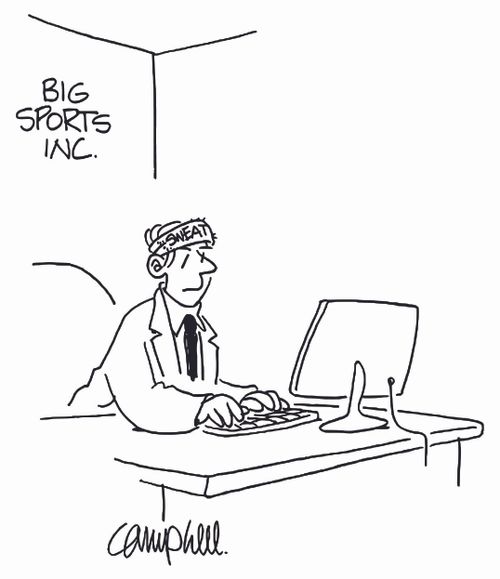 Man at computer at sports company wears sweat band on head.
