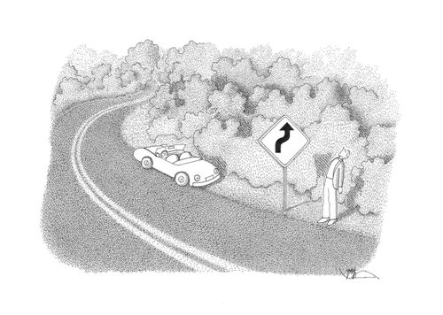 Man stops to look up at a road sign.