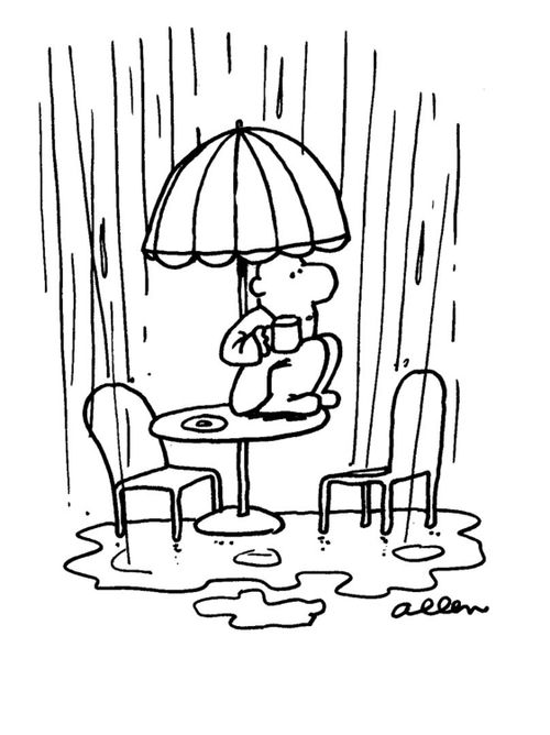 Man on sidewalk cafe having coffee, it's raining and he's sitting on the table under the umbrella.