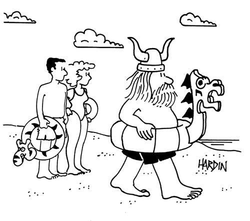 Viking on beach with rubber ring shaped like viking ship.