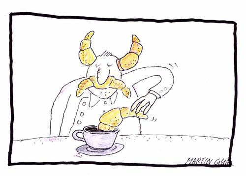 Man playing with croissants at the breakfast table