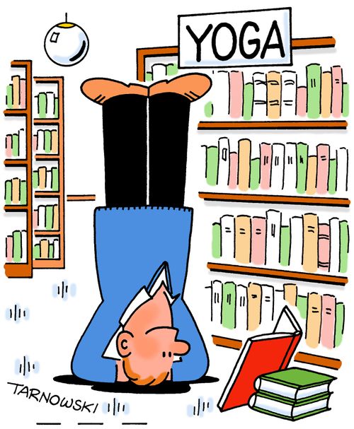 Man reading a yoga book while standing on his head.