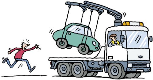 A man chasing tow truck as his car is hoisted onto flat bed.