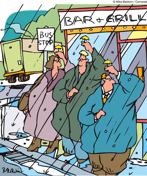 People at a bus stop outside a bar and grill shelter from the rain with tiny little cocktail umbrellas.
