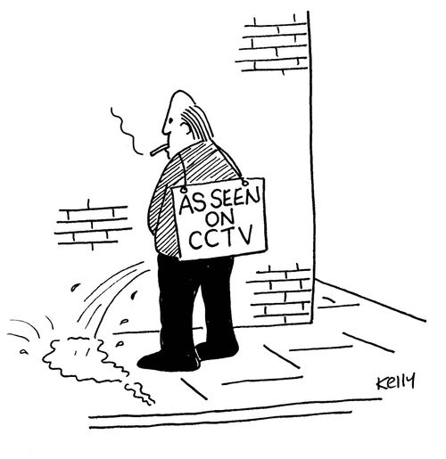 Man urinating against wall with sign on back which says 'as seen on CCTV'.