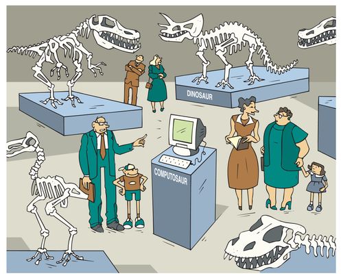 Man and son looking at a computer displayed among dinosaurs skeletons in museum.