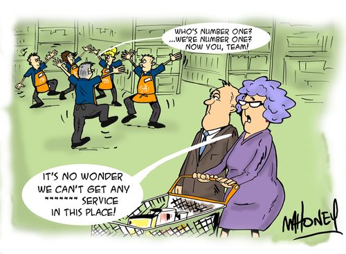 A shopping couple commenting on the store staff at a team brief session.