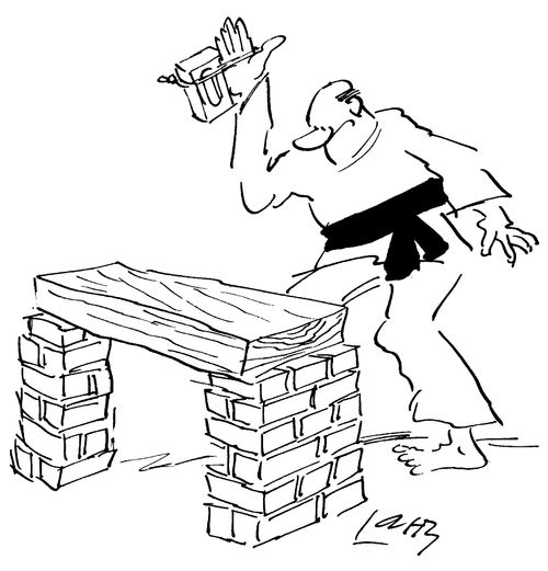 Man attempting to karate chop a pile of bricks cheats by tying a brick to his hand
