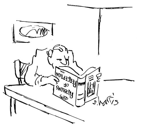 Man reading problems of perception upside-down.