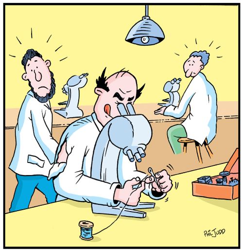 Scientist using his microscope to thread a needle to repair his torn shirt.
