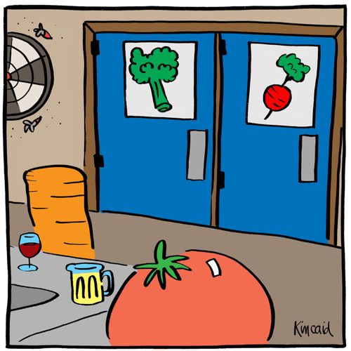 Vegetables at a bar with vegetable bathroom signs in the background.