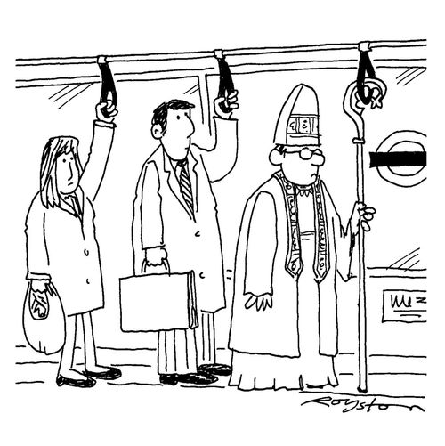 Commuting bishop uses crook to hold on to tube train strap.