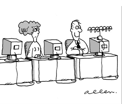 In office, with computers, man is has swapped a television for his computer
