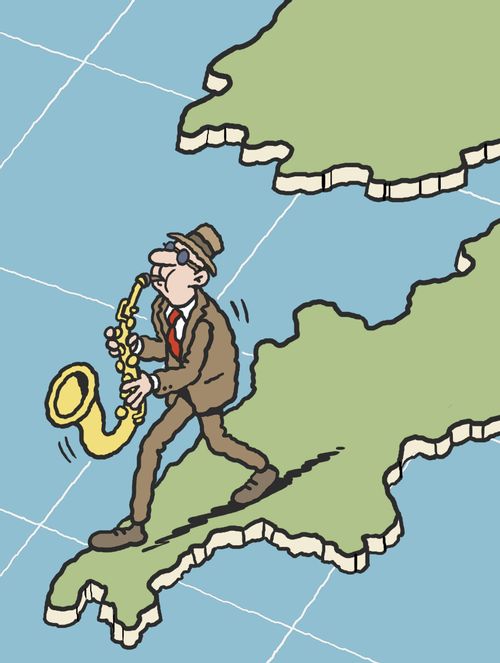 Saxophonist playing on the map of Cornwall.