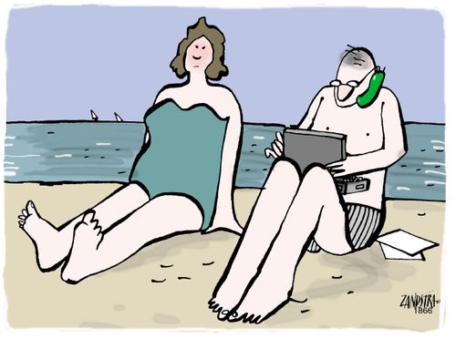 Man on a beach with a mobile phone and a laptop.