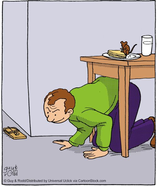 Man staking out a mouse trap from under a table while the mouse raids the food above him.