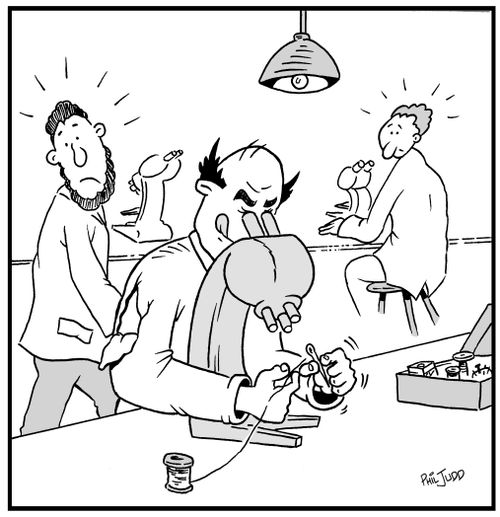 Scientist using his microscope to thread a needle to repair his torn shirt.