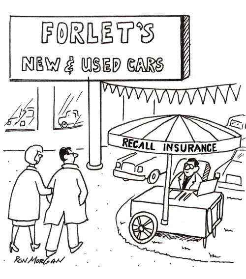 Man sells recall insurance outside car dealership.