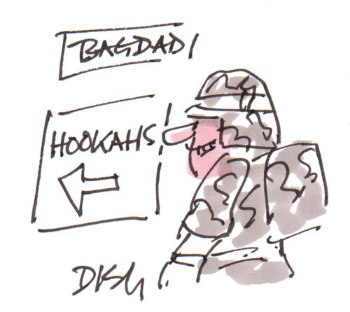 US soldier reading a sign for 'Hookahs' in Iraq.