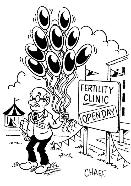Fertility clinic open day - Man holding balloons shaped like sperm.