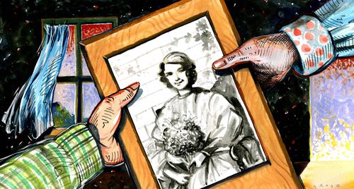 Two hands holding a picture of a girl.