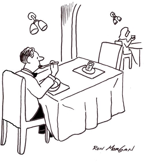 Man, dining at formal restaurant, has a place set for his beloved cell phone across the table.