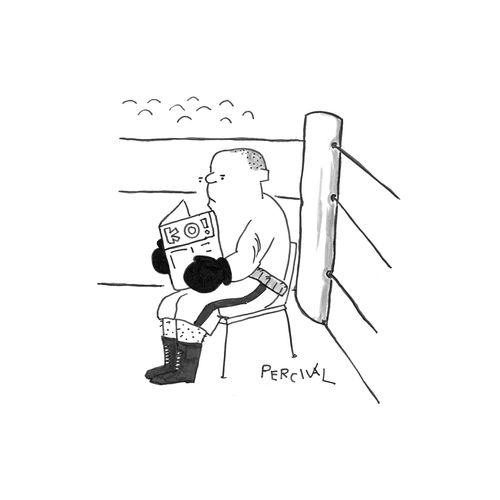 Boxer sitting in the ring reading 'KO' magazine.