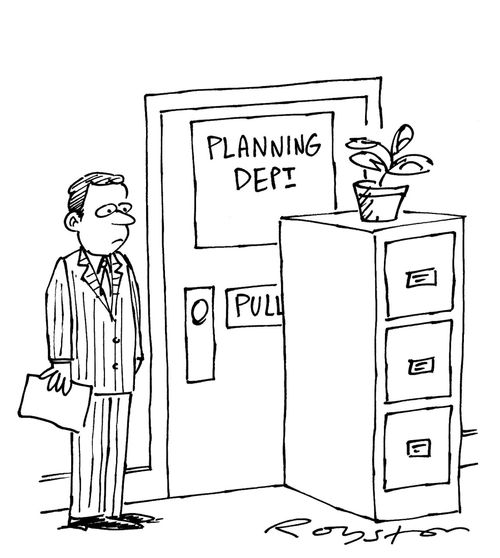 Man in office notices file cabinet placed in front of the door to the Planning Department.