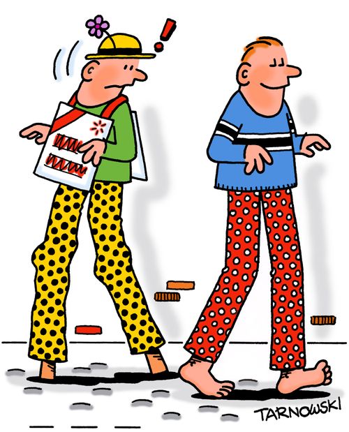 Tall man next to a stilt-walker.
