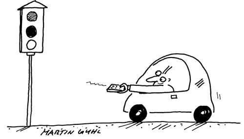 Man in a car with a remote control for the traffic lights
