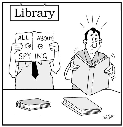 Man reading a book in the library. Notices a man next to him reading all book about spying.