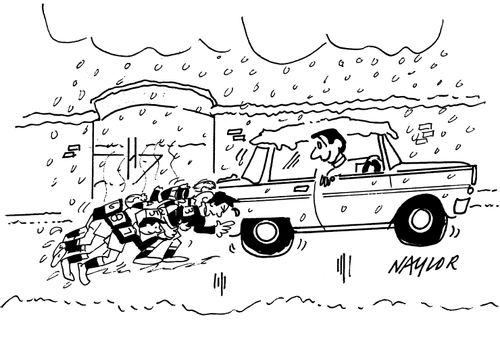 Rugby players pushing car in the snow.