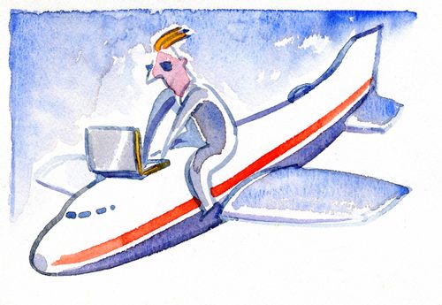 Man on a laptop on the back of a plane.