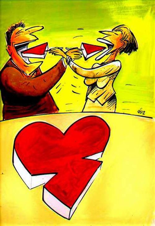 A couple feeding each other pieces of a heart cake.