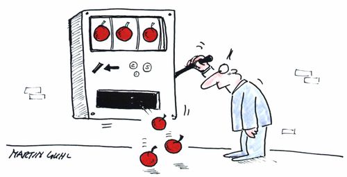 Man playing a fruit machine wins three cherries