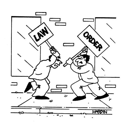 Two men fight with Law and Order signs.