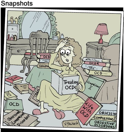 Woman reads a mountain of books, all about OCD.